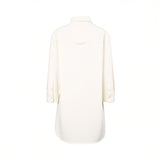 Back studio view of the Citizens of Humanity white long-sleeve shirt, highlighting the clean back yoke stitch line, locker loop detail, and flowing high-low hemline.