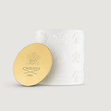 White cylindrical CREED candle vessel with embossed horse and crest motifs, featuring a gold-toned metallic lid with debossed