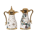A pair of luxury CASA BLU thermoses for Arabic coffee and tea, featuring white bodies with colorful geometric star patterns and ornate gold-plated handles and lids.
