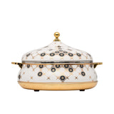 Casa Blu luxury white insulated food warmer with gold-plated base and handles, decorated with black and gold geometric sunburst patterns on the body and lid.