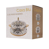 Casa Blu insulated food warmer with a white body covered in a multicolor geometric star mosaic pattern, featuring gold-plated handles and base.