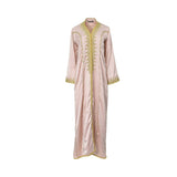 Front view of a CASA JOHARA FASHION rose dust satin caftan with elaborate gold embroidery on the neckline and pinstripe details.