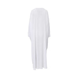 Back view of the white flowy kaftan showing the oversized butterfly drape and clean, minimalist white fabric.