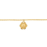 A direct macro shot focusing on the center of the Escada Ava bracelet, highlighting the detailed curves of the gold-plated flower charm and the crisp double-E monogram logo at its core.
