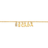 A detailed linear macro shot focusing on the center charms of the Escada Belle bracelet, highlighting the rows of micro-crystals on the letter E followed by the polished gold-plated S, C, A, D, and A links.