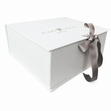 White rectangular gift box with a green 'STORY LORIS' logo on the lid and a grey satin ribbon tied in a bow.