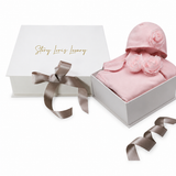 Pink sleepsuit set with a long-sleeved sleepsuit featuring two floral appliques on the chest and a matching hat with one flor