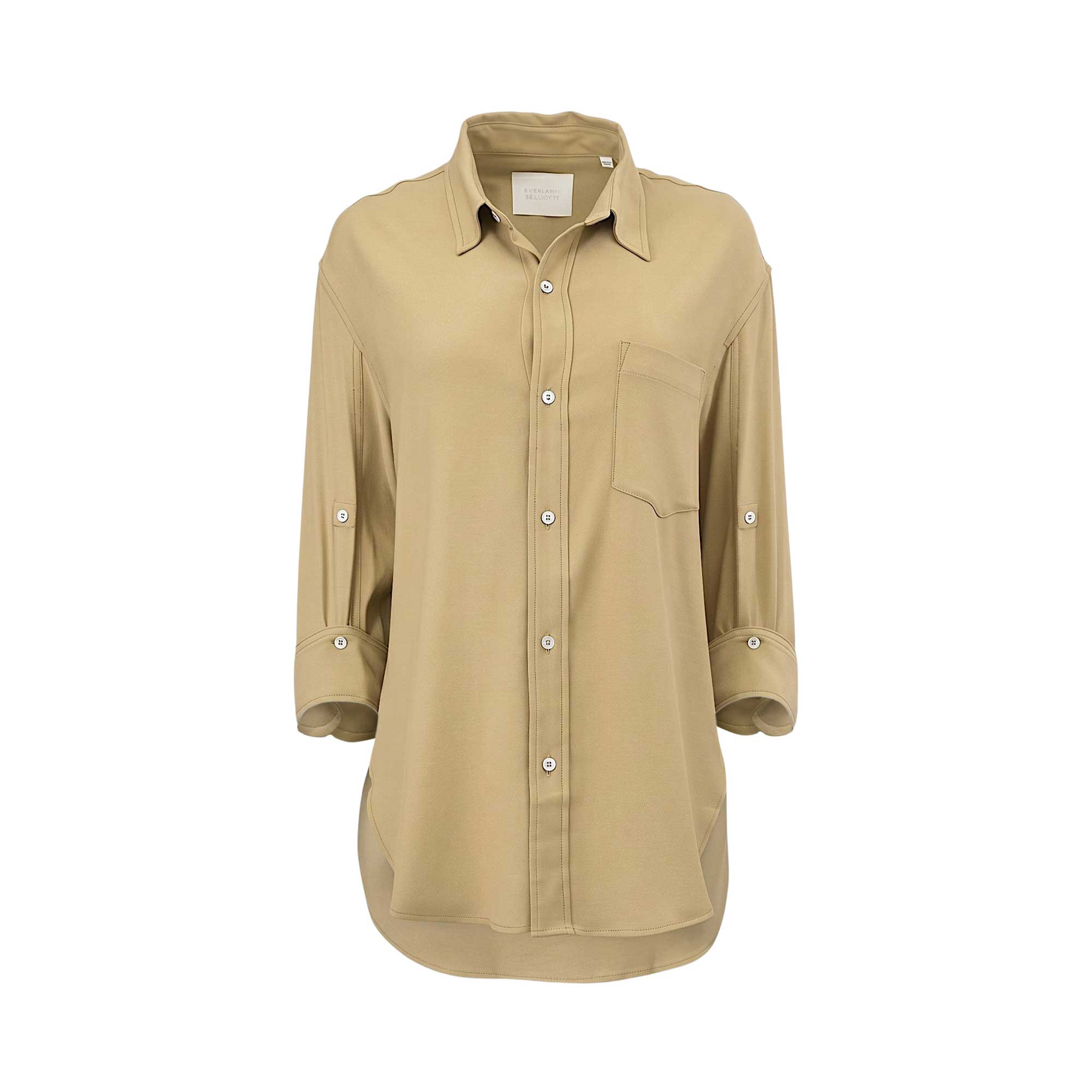 Front studio view of a Citizens of Humanity beige button-down shirt, showcasing its relaxed point collar, single chest pocket, and curved tunic hem against a white background.