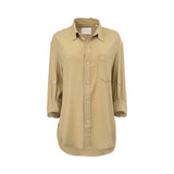 Front studio view of a Citizens of Humanity beige button-down shirt, showcasing its relaxed point collar, single chest pocket, and curved tunic hem against a white background.