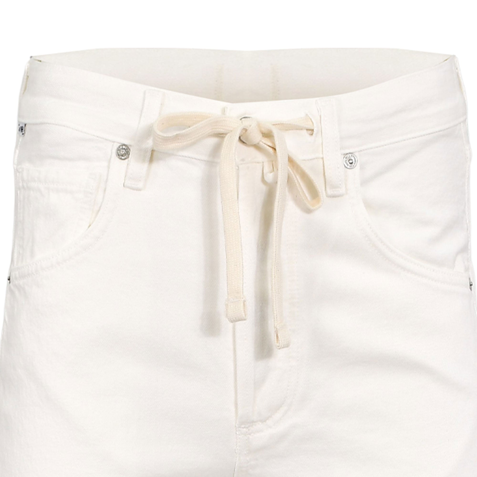 Close-up structural detail of the front waistband on the Citizens of Humanity white trousers, highlighting the knotted cream drawstring, belt loops, and polished silver rivets.