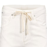 Close-up structural detail of the front waistband on the Citizens of Humanity white trousers, highlighting the knotted cream drawstring, belt loops, and polished silver rivets.