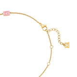 A close-up studio photograph of the necklace closure system, showcasing the gold-plated lobster claw clasp, adjustment jump rings along the chain track, a final pink enamel station link, and the dangling golden monogram end tag.