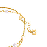 A high-detail close-up shot focusing on the polished gold-plated lobster claw closure, the links of the adjustable extension chain, and the suspended solid Escada back-to-back monogram logo tag.