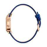 Side view showcasing the slimness of the rose gold teardrop case head, the minimalist crown design, and the profile thickness of the blue leather strap.