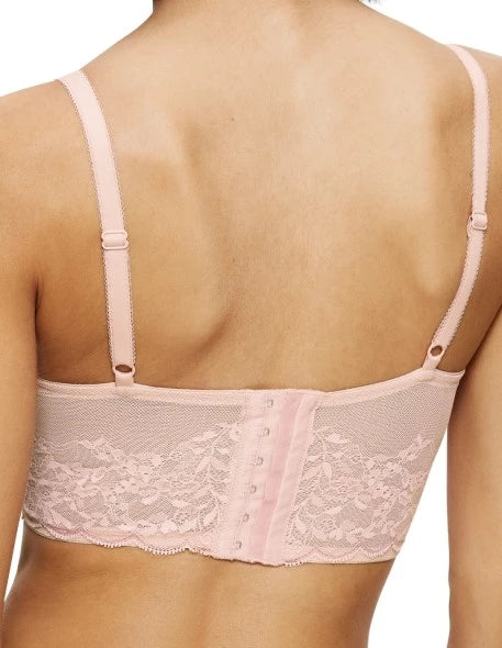 Close-up back view of model wearing the Triumph Sensual Spotlight light pink corset, showcasing the intricate lace panels and the adjustable straps with back closure. Now Available Online