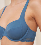 Close-up side view of second Model wearing the Triumph Natural Spotlight blue wired bra, showcasing the lace-covered cups and supportive underwire design. Available Online Now