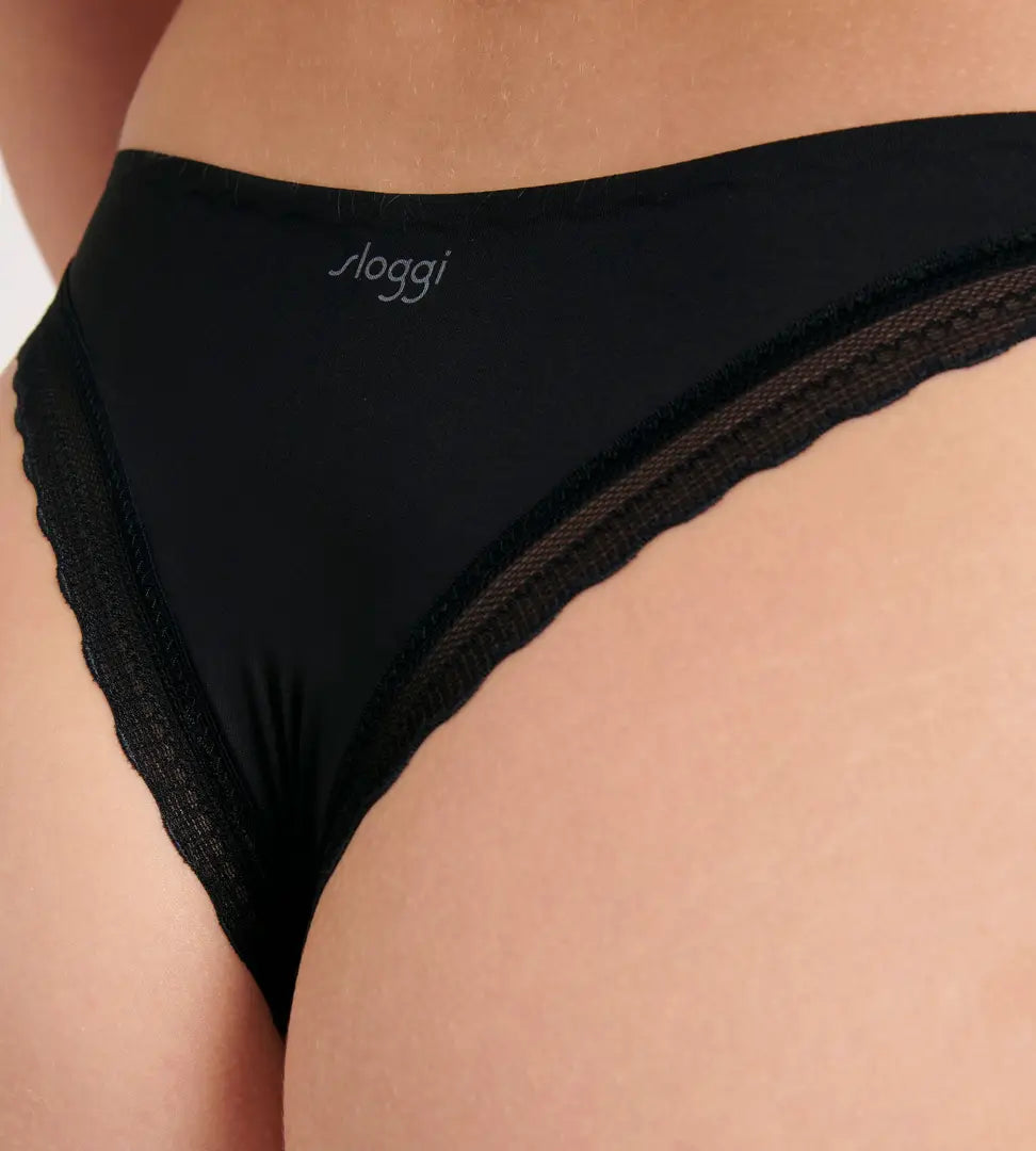 Close-up view of model wearing the Sloggi Body Adapt Twist black Brazil panty, showing the mesh waistband and high-cut leg. Shop Online Today