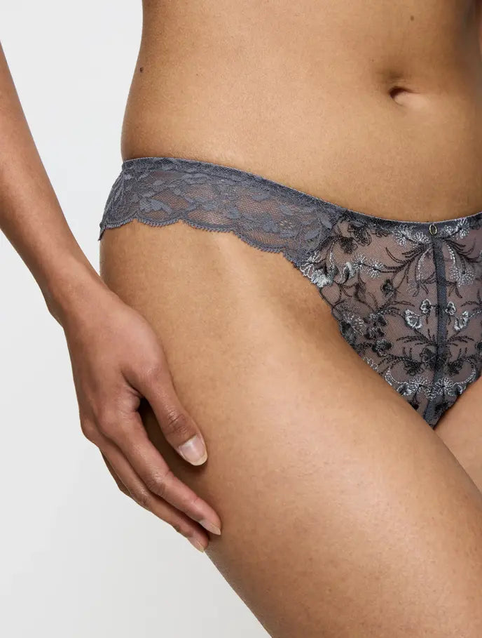 Close-up view of model wearing the Triumph Sensual Spotlight grey highleg Brazilian panty, showcasing the sheer mesh and high-cut lace detailing. Shop Online Today