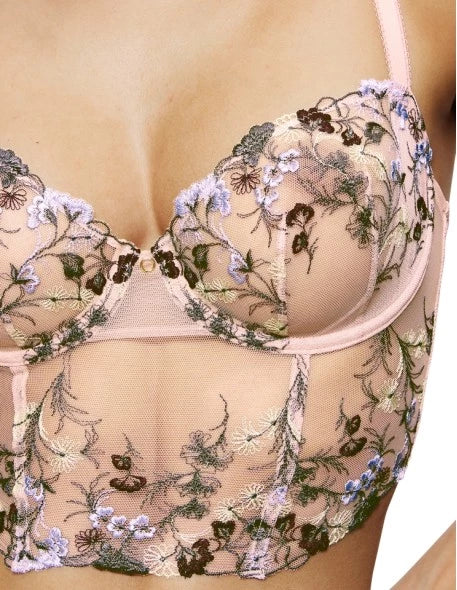 Close-up view of model wearing the Triumph Sensual Spotlight light pink corset, showcasing the intricate lace panels and structured waist design. Now Available Online