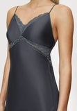 Close-up view of model wearing the Triumph Silky Sensuality dark grey nightdress, highlighting the lace-trimmed neckline and silky fabric drape. Find Online Now