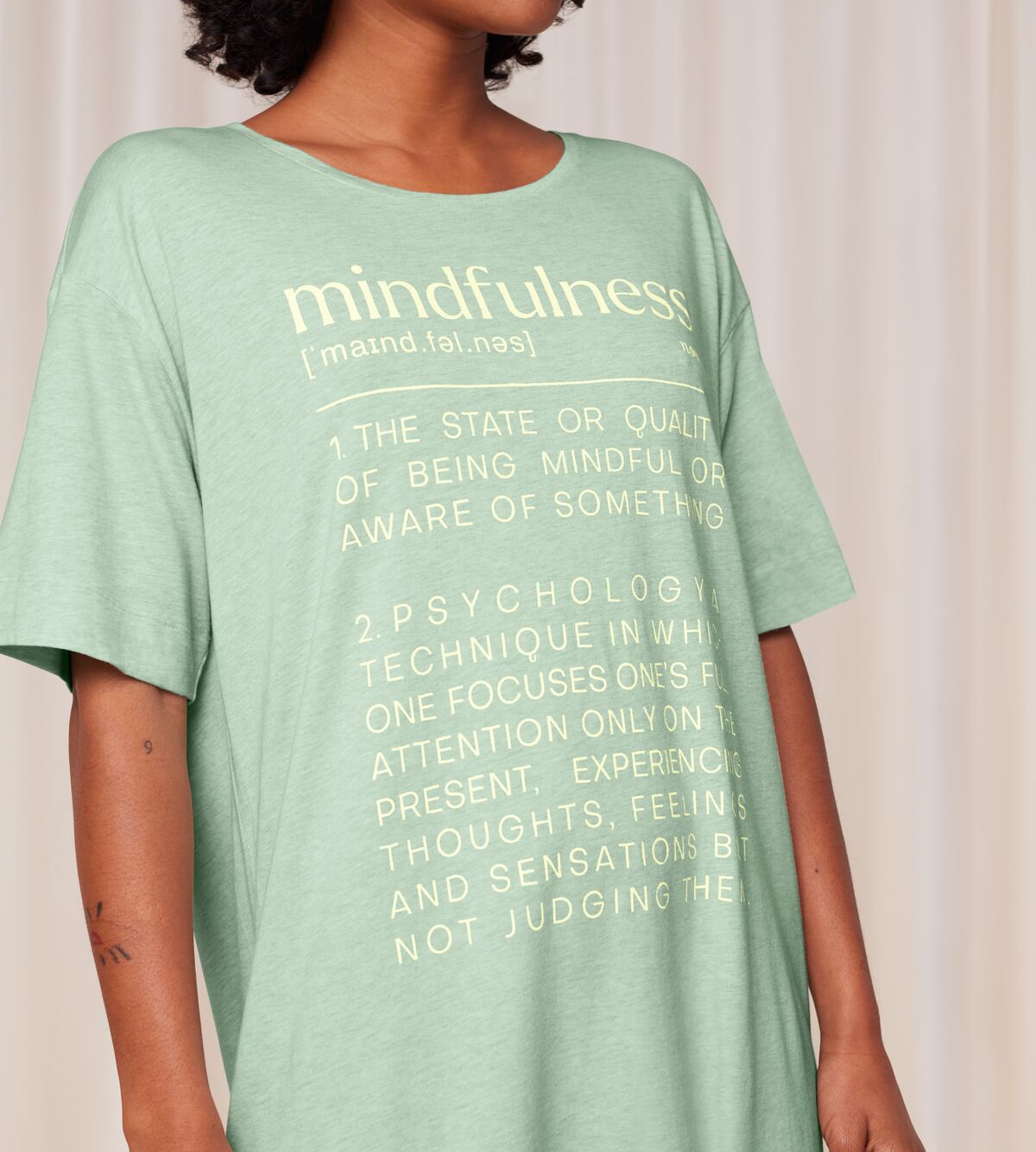 Close-up view of model wearing the Triumph green short sleeve nightdress, highlighting the relaxed silhouette and soft-touch fabric. Shop the Latest Online