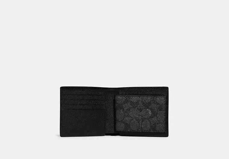 Interior view of an open black Coach wallet showing the signature canvas coin pocket with a snap closure and multiple credit card slots.