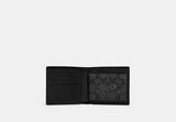 Interior view of an open black Coach wallet showing the signature canvas coin pocket with a snap closure and multiple credit card slots.