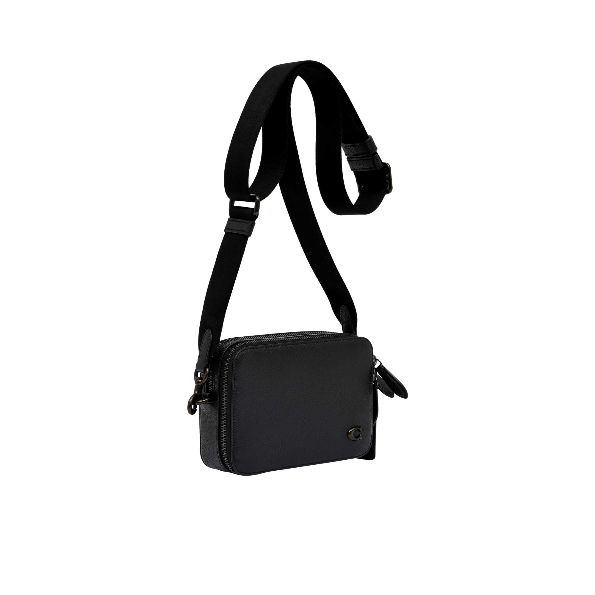 Side profile view of the silver Coach Tabby messenger bag showing its expandable multi-gusset structure, neat hand-painted edge dyes, and the silver-tone dogleash clasp attaching the wide strap.