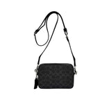 Back view of the Coach Tabby messenger bag in classic black leather, showing a clean rear panel with a full-width exterior slip pocket and detailed stitching.