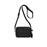 Front view of the Coach Tabby Messenger Bag 19 in black leather, featuring a structured square silhouette, an iconic tonal black signature C logo on the flap, and a wide adjustable crossbody strap against a white background.