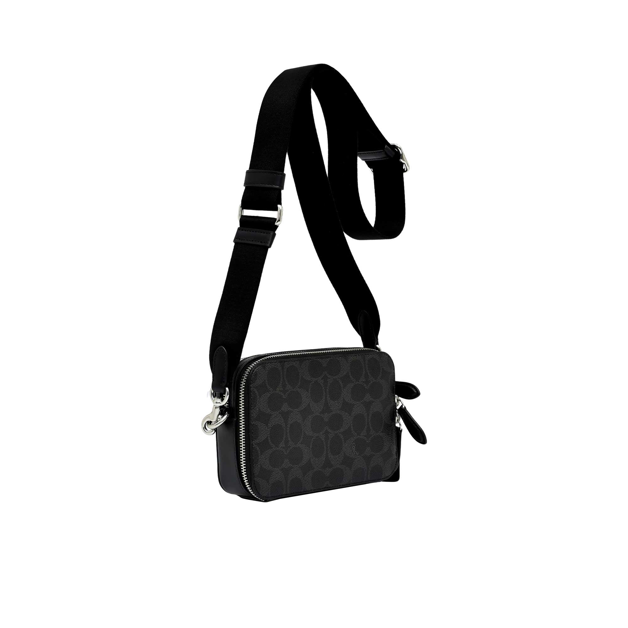 Side profile view of the black Coach Tabby messenger bag showing its expandable multi-gusset structure, neat finished edges, and the black dogleash clasp attaching the wide strap.