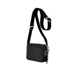 Side profile view of the black Coach Tabby messenger bag showing its expandable multi-gusset structure, neat finished edges, and the black dogleash clasp attaching the wide strap.