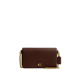 Front-facing view of the Coach Hayden clutch bag showing the signature "C" pattern, gold-tone hardware snap, and removable chain strap.