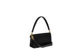 Side-angle view of the black Coach Tabby bag highlighting the structured multi-compartment design and gold-tone hardware.