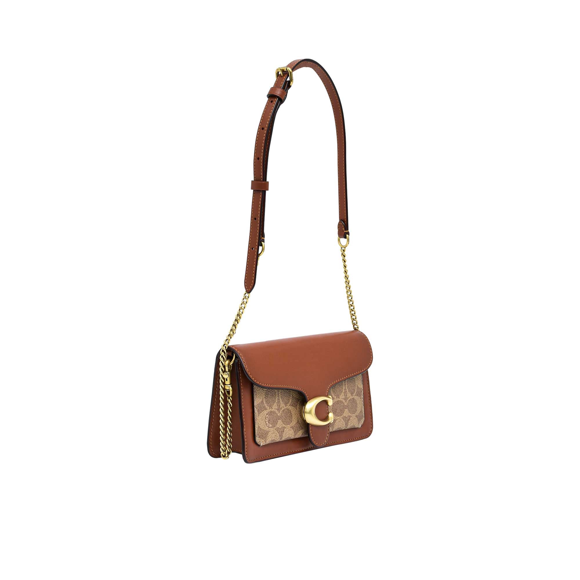 Side view of the metallic silver Coach Tabby bag showing the dual-gusset expandable structure, smooth hand-painted edge stains, and secure silver dogleash clips holding the detachable top handle.
