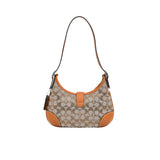 Handbag with patterned design and orange accents on a white background.