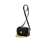 Side view of the metallic silver Coach wristlet displaying its slim, expandable gusset design and hand-painted edges with polished silver hardware attachment clips.