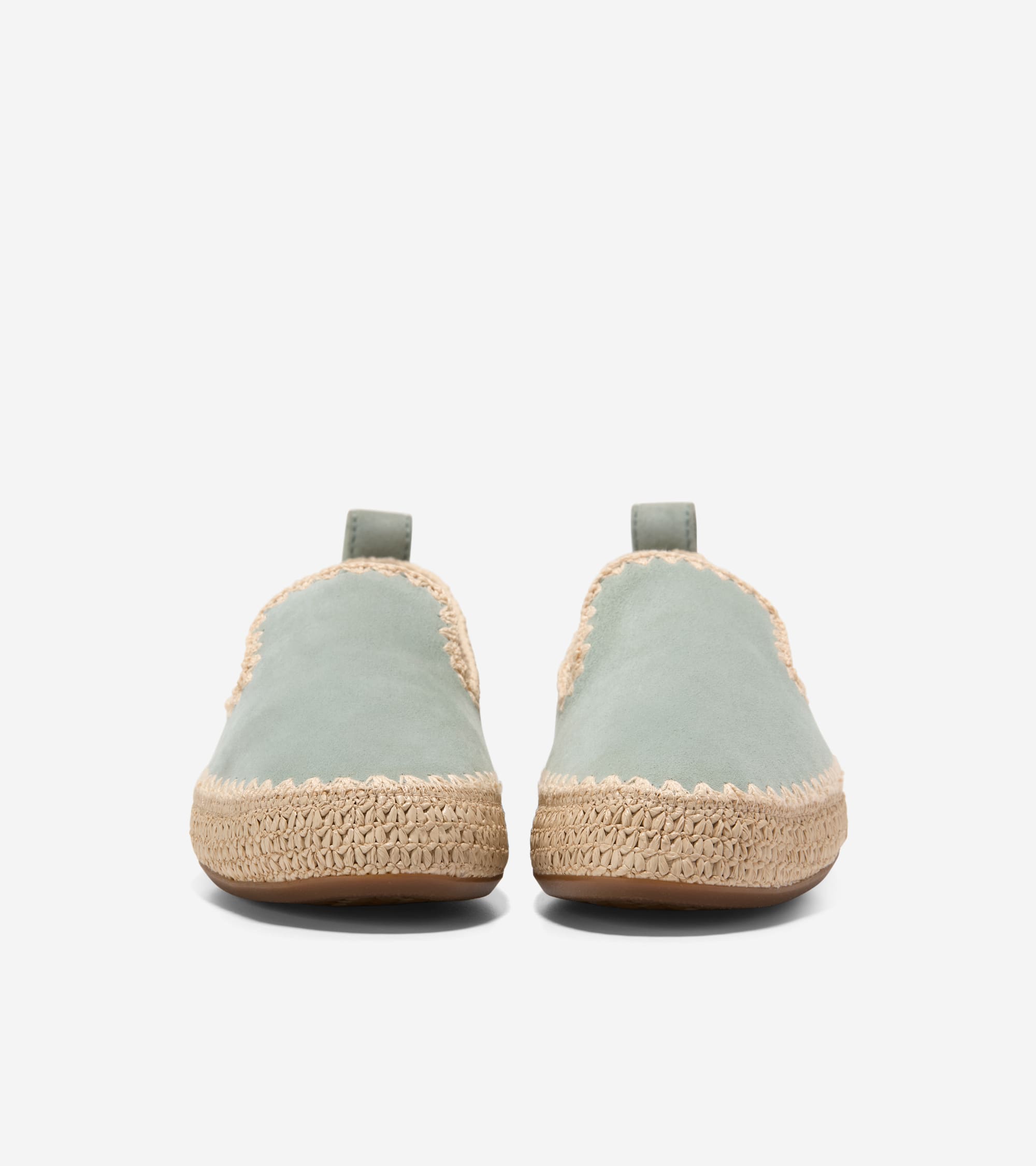 Cole Haan Women's Cloudfeel Asbury Slip-On Loafers Pair of light blue espadrilles with cork soles on a white background