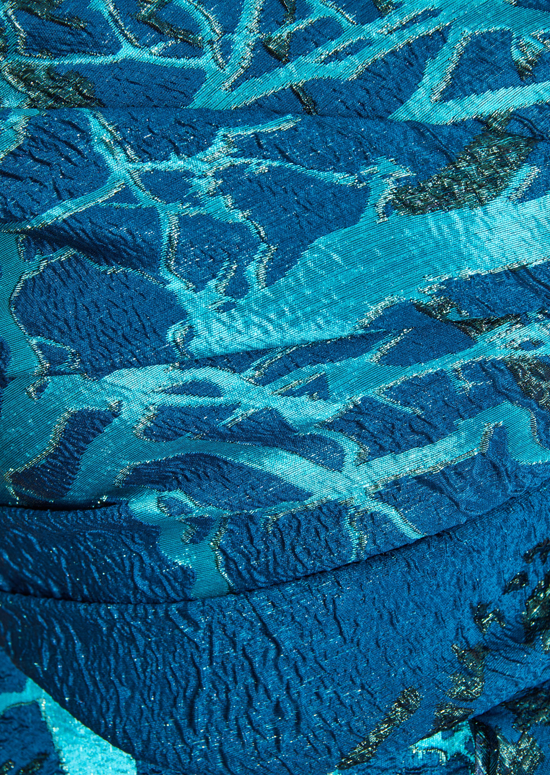 Long dress fabric in crinkled deep blue and turquoise with an abstract pattern of silver-toned metallic threads.