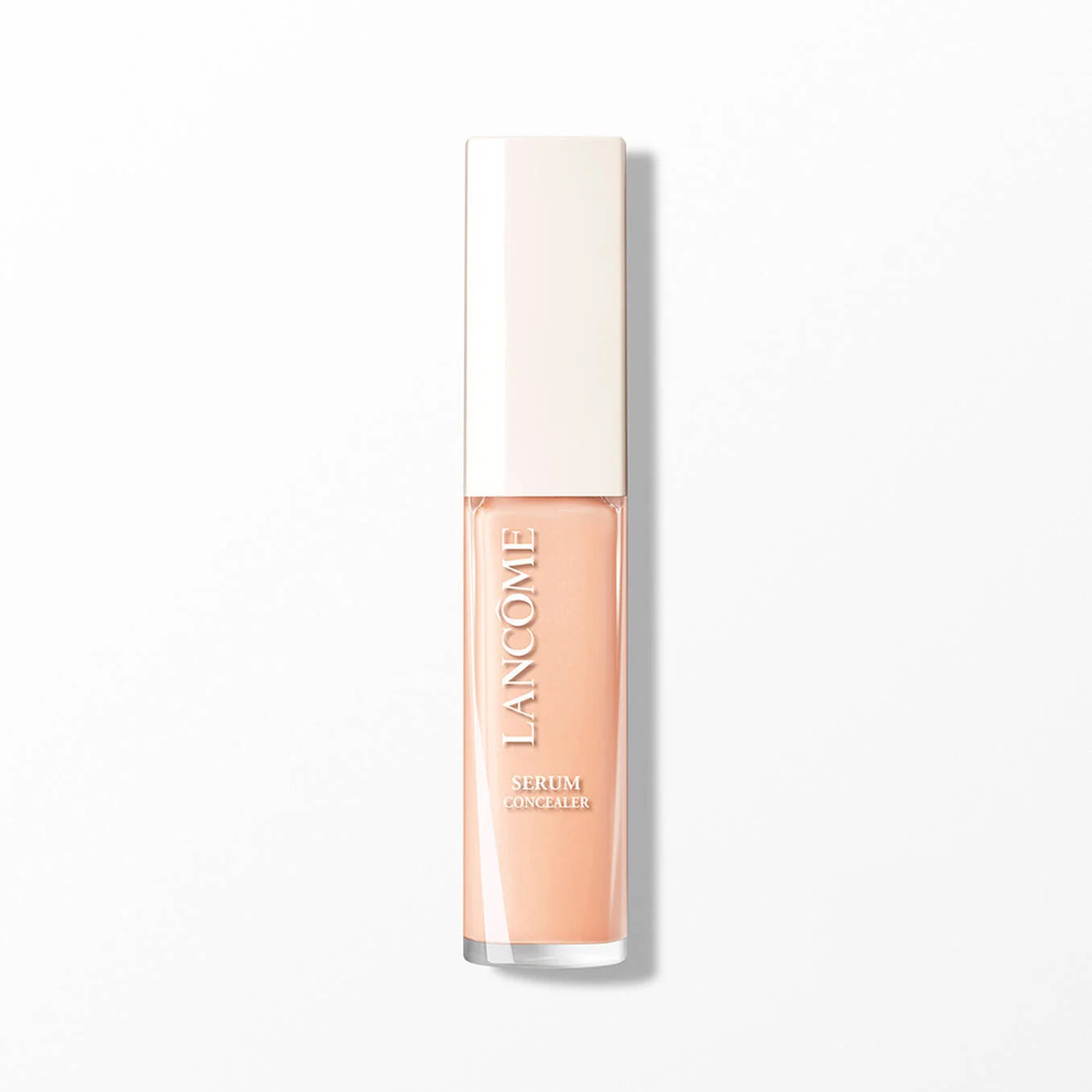 Rectangular Lancome serum concealer bottle with a clear base showing peachy liquid and an opaque light beige cap.