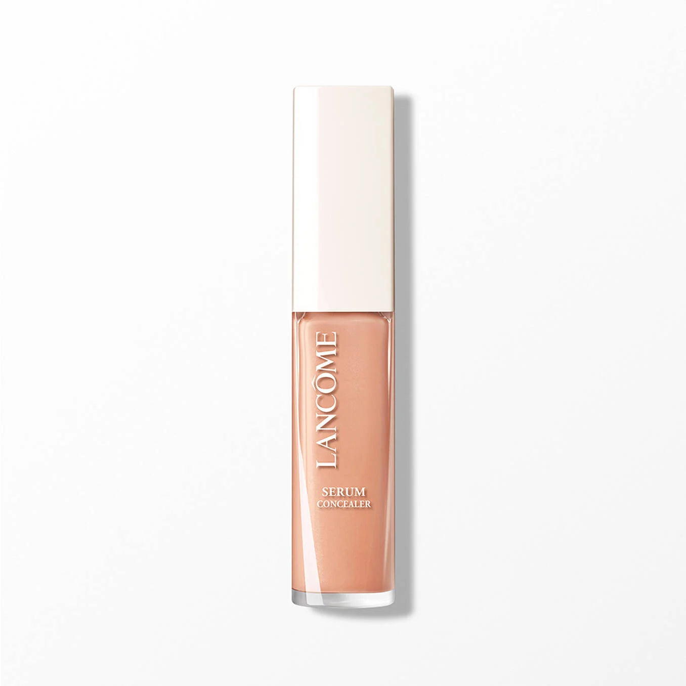 Rectangular concealer tube with an off-white cap and clear bottle containing peach-toned liquid. 'LANCOME SERUM CONCEALER' pr