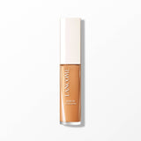 Lancome serum concealer in a rectangular transparent tube with a white cap, showing a medium brown liquid.