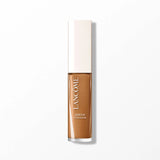 Rectangular concealer bottle with clear bottom showing medium brown liquid and an off-white cap. White text: 'LANCÔME SERUM C