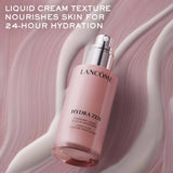 Pink glass bottle of Lancome Hydra Zen Liquid Moisturizer with a silver-toned pump dispenser.