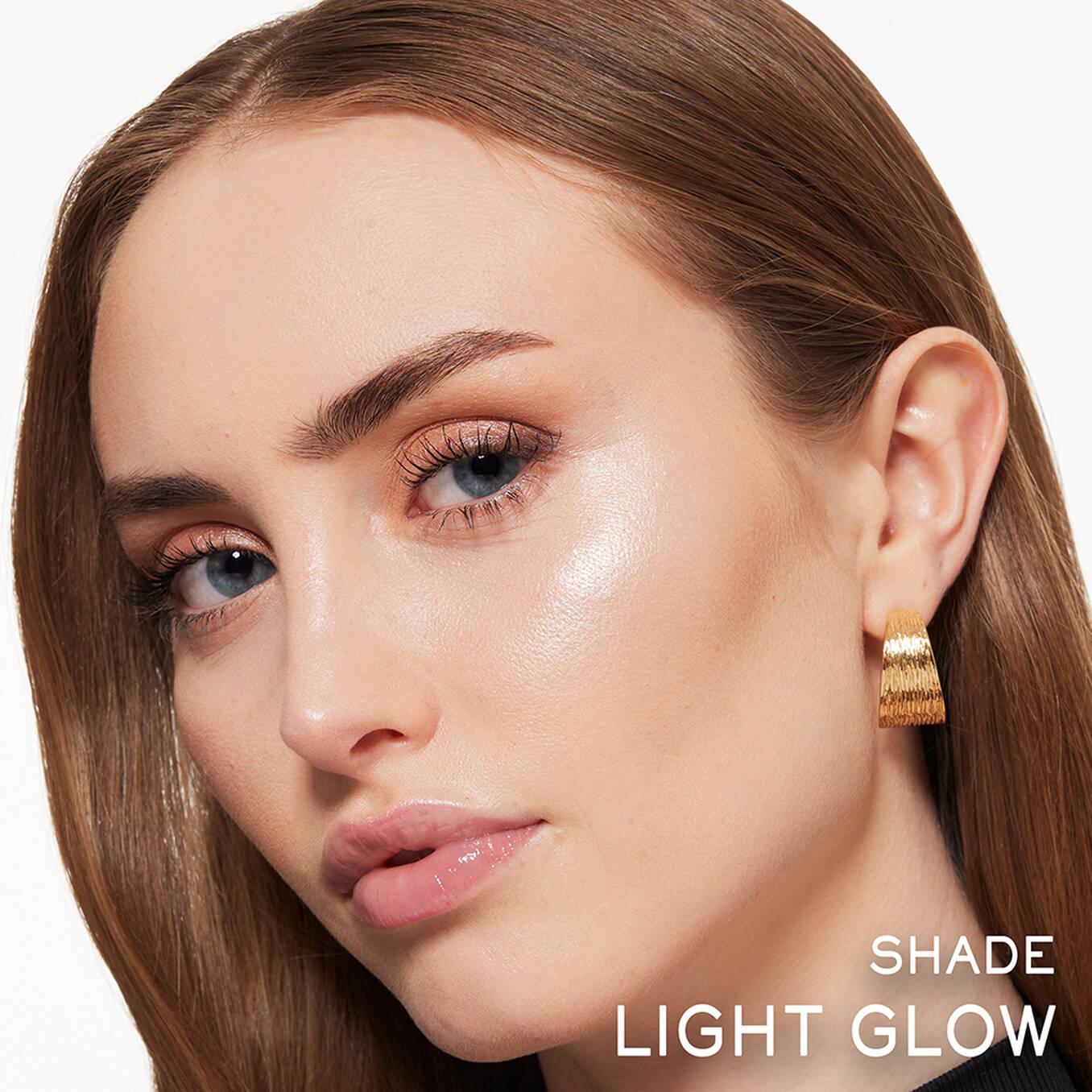 Lancome powder highlighter in Light Glow shade applied to cheekbone, providing a radiant, luminous finish