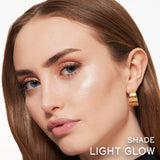 Lancome powder highlighter in Light Glow shade applied to cheekbone, providing a radiant, luminous finish