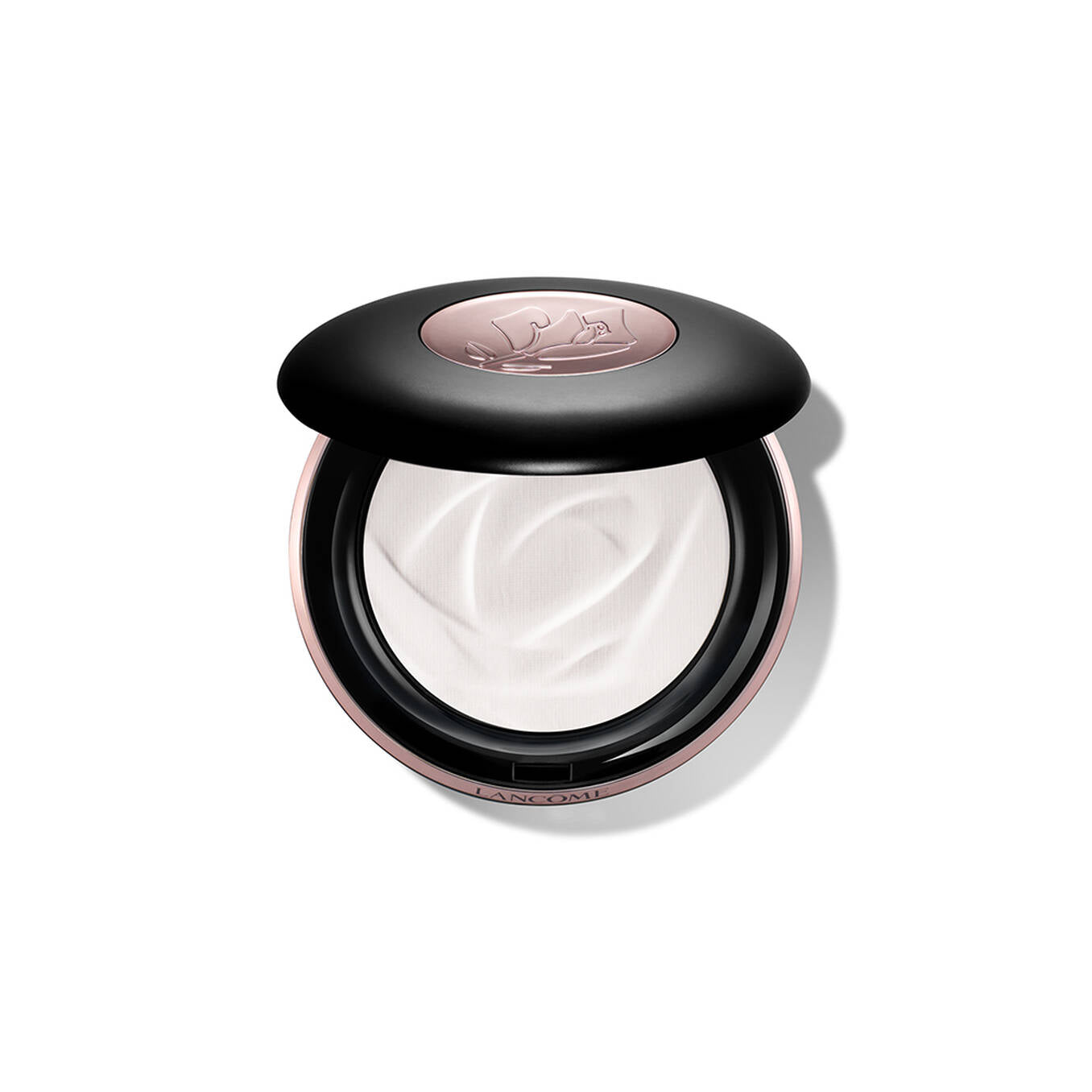 Open round compact with a black lid, rose-gold toned base, and a rose-gold toned oval insert with an embossed rose. Contains
