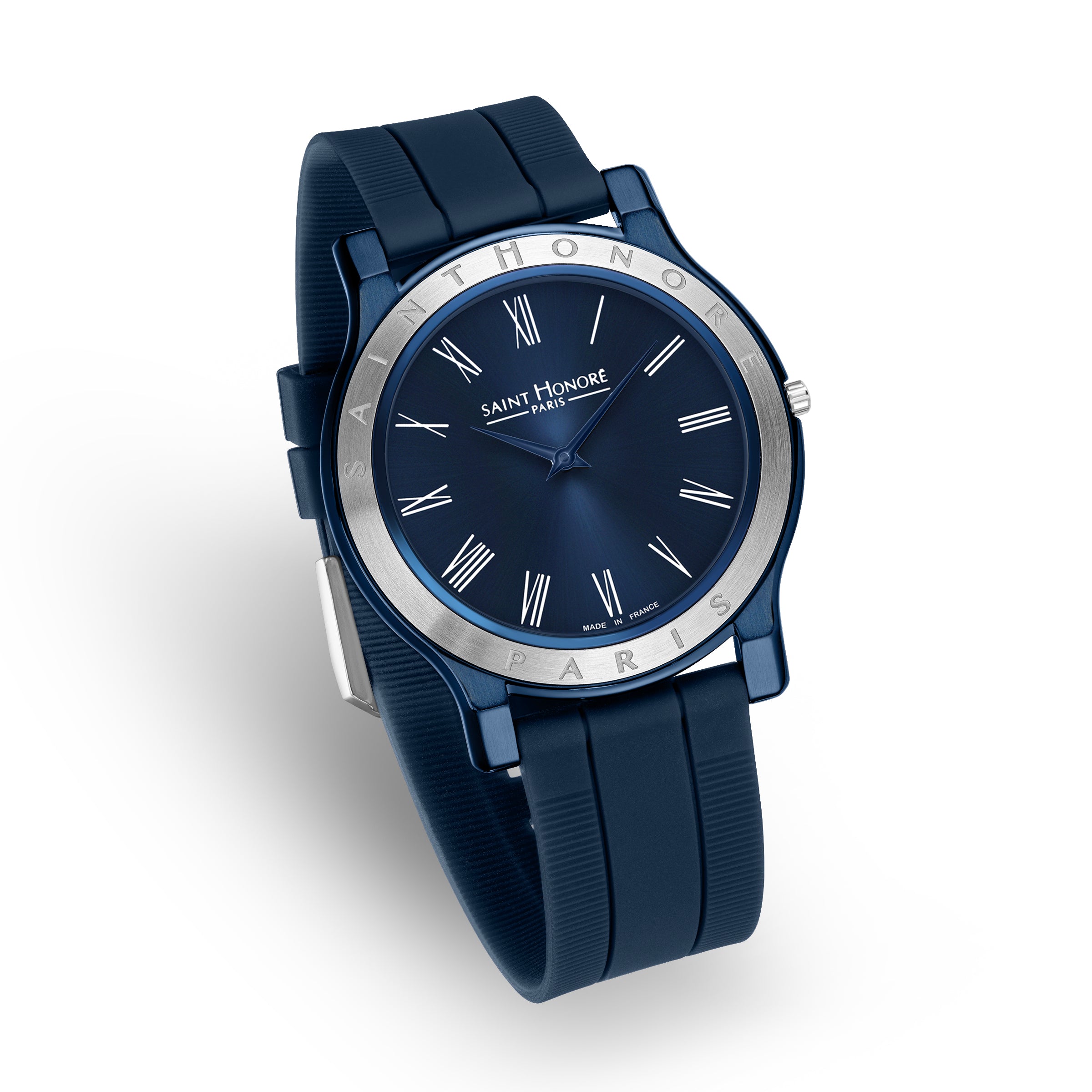 Blue watch with a round blue case, silver-toned bezel, blue dial with silver-toned Roman numerals, and a blue ribbed silicon