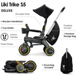 Black Doona Liki Trike S5 with canopy, seat, wooden handlebars, black wheels with yellow rims, storage bag, and travel bag.