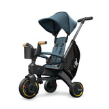 Doona Liki Trike S5 in ocean blue, featuring a dark grey frame, black storage bag, and yellow wheel accents.